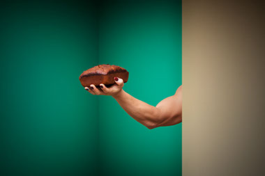 Felix Ossa - Domestic - Image of a man’s hand holding a loaf of bread